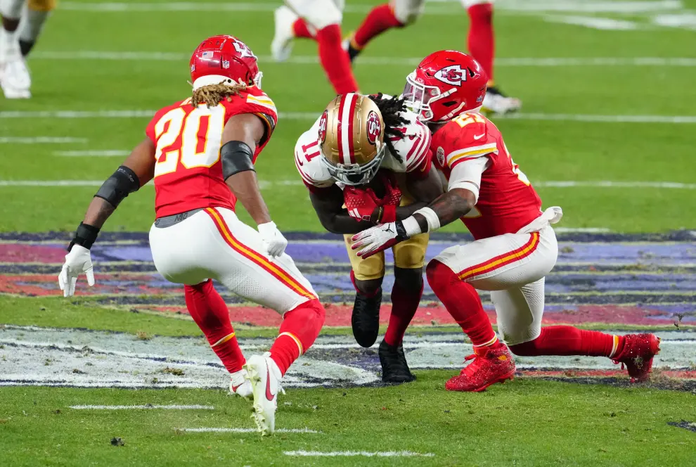 Feb 11, 2024; Paradise, Nevada, USA; San Francisco 49ers wide receiver Brandon Aiyuk (11) is tackled by Kansas City Chiefs safety Mike Edwards (21) in the fourth quarter in Super Bowl LVIII at Allegiant Stadium. Mandatory Credit [[[REUTERS VOCENTO]]] FOOTBALL-NFL-KC-SF/