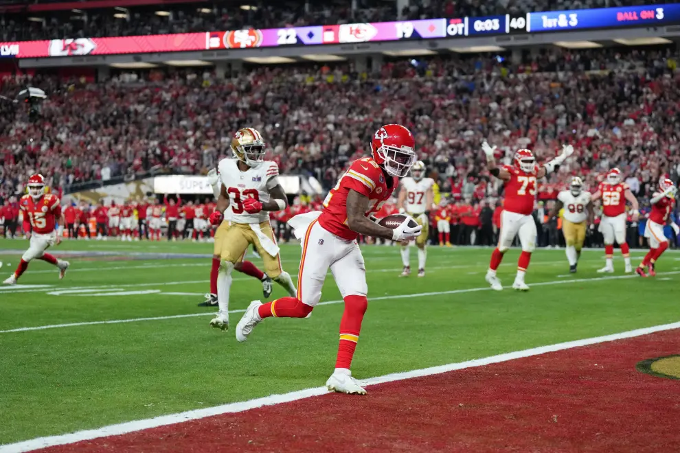 Feb 11, 2024; Paradise, Nevada, USA; Kansas City Chiefs wide receiver Mecole Hardman Jr. (12) scores a touchdown against the San Francisco 49ers in overtime during Super Bowl LVIII at Allegiant Stadium. Mandatory Credit [[[REUTERS VOCENTO]]] FOOTBALL-NFL-KC-SF/