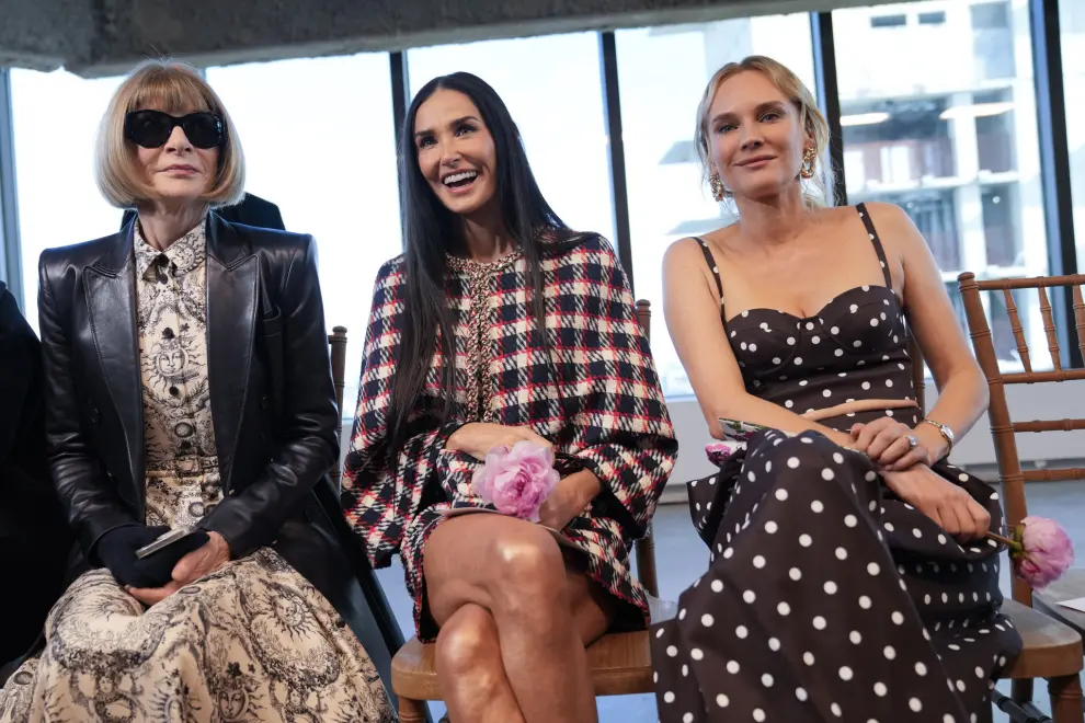 Anna Wintour, left, editor-in-chief of American Vogue poses for photographers with actresses Demi Moore, center and Diane Kruger before the Carolina Herrera collection is modeled during Fashion Week, Monday, Feb. 12, 2024, in New York. (AP Photo/Mary Altaffer)