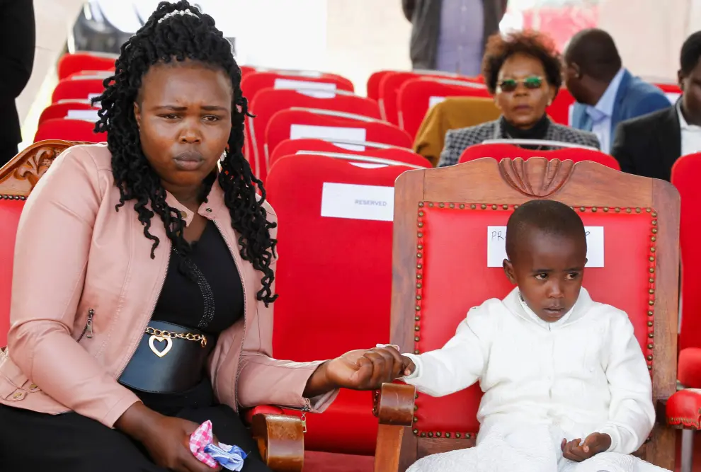 Asenath Rotich, a widow of the of Kenyas marathon world record holder Kelvin Kiptum, who died in a road accident, and her daughter Precious sit during his funeral service at Chepkorio show ground, Elgeyo Marakwet County, Kenya February 23, 2024. REUTERS/Monicah Mwangi [[[REUTERS VOCENTO]]]