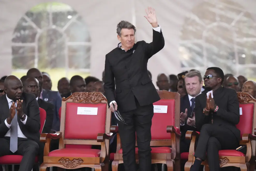 The World Athletics President Sebastian Coe, waves to the public ahead of Kelvin Kiptum's burial in Elgeyo Marakwet, Kenya, Friday Feb. 23, 2024. World marathon record holder Kelvin Kiptum was buried Friday following his death in a road accident, as Kenyans castigated the government for not doing enough to protect and support country's famed athletes. (AP Photo/Brian Inganga)