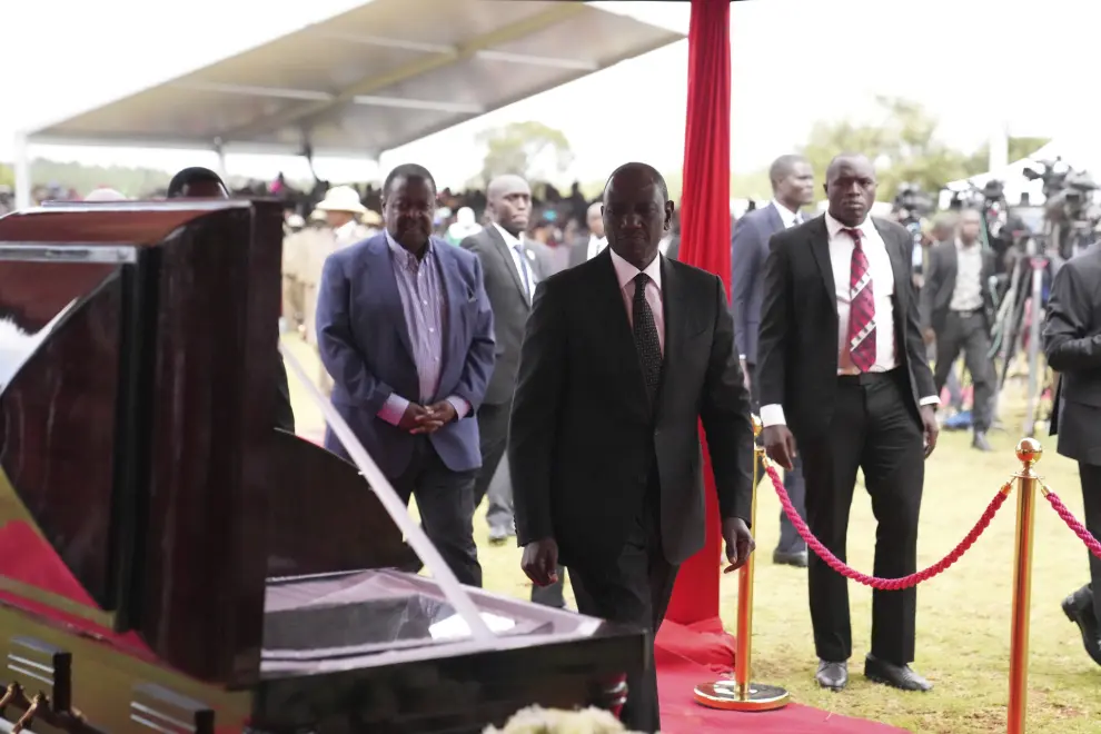 Kenya President William Ruto, pays his last respect to marathon record holder Kelvin Kiptum ahead of his burial, in Elgeyo Marakwet, Kenya, Friday Feb. 23, 2024. World marathon record holder Kelvin Kiptum was buried Friday following his death in a road accident, as Kenyans castigated the government for not doing enough to protect and support country's famed athletes. (AP Photo/Brian Inganga)