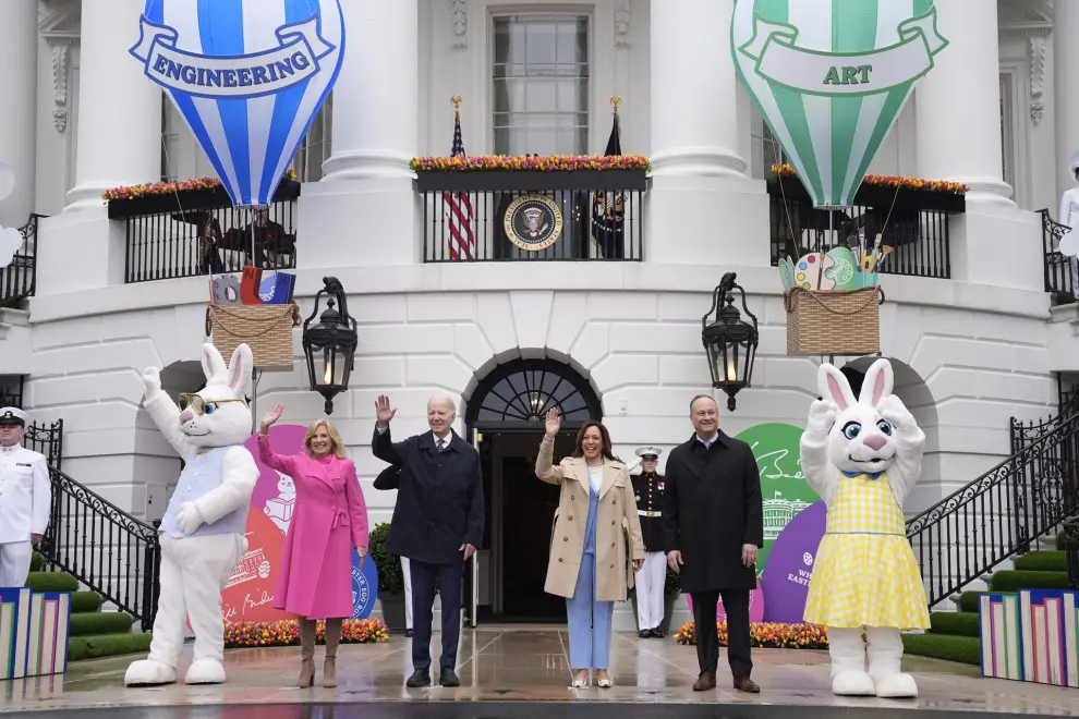 President Joe Biden, center left, and Vice President Kamala Harris, center right, accompanied by first lady Jill Biden, left, and second gentleman Doug Emhoff, right, wave at the White House Easter Egg Roll on the South Lawn of the White House, Monday, April 1, 2024, in Washington. (AP Photo/Evan Vucci)