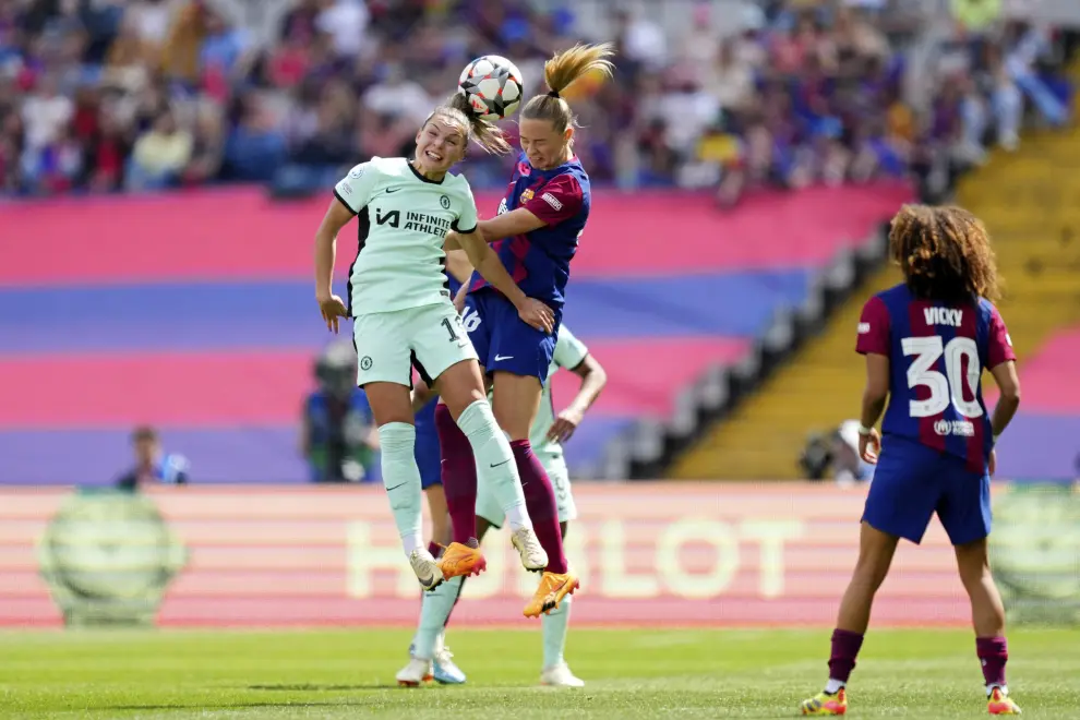 Barcelona's Fridolina Rolfo jumps for the ball with Chelsea's Johanna Rytting Kaneryd, left, during the women's Champions League semifinals, first leg, soccer match between FC Barcelona and Chelsea FC at the Olympic Stadium, in Barcelona, Spain, Saturday, April 20, 2024. (AP Photo/Jose Breton)
