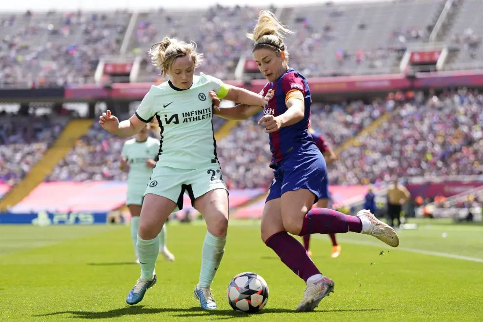 Chelsea's Erin Cuthbert vies for the ball with Barcelona's Alexia Putellas, right, during the women's Champions League semifinals, first leg, soccer match between FC Barcelona and Chelsea FC at the Olympic Stadium, in Barcelona, Spain, Saturday, April 20, 2024. (AP Photo/Jose Breton)