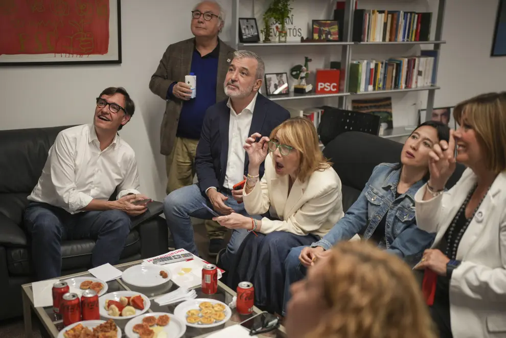 Socialist candidate Salvador Illa, left, watches early results on TV with other members of the PSC ( Socialist Party of Catalonia ) at the party headquarters in Barcelona, Sunday May 12, 2024. A total of nine parties are running and no single one is expected to come close to winning enough votes to reach the absolute majority, so deal-making will be critical. Third from left is Barcelona's Mayor Jaume Collboni (AP Photo/Emilio Morenatti)