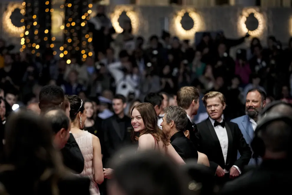 Emma Stone, centre, poses for photographers upon departure from the premiere of the film 'Kinds of Kindness' at the 77th international film festival, Cannes, southern France, Friday, May 17, 2024. (Photo by Andreea Alexandru/Invision/AP)