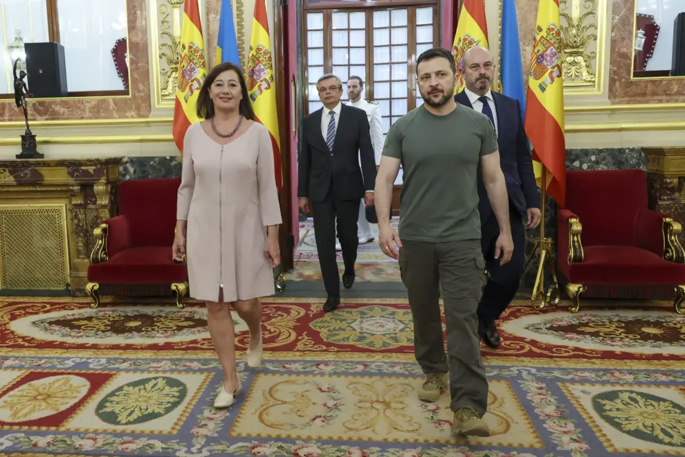 El presidente ucraniano, Volodímir Zelenski (c), firma el libro de visitas en el Congreso de los Diputados antes de su reunión con la presidenta del Congreso, Francina Armengol