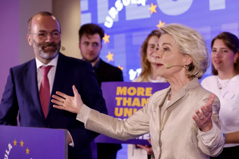 Lead candidate for the European Commission, current European Commission President Ursula von der Leyen, right, speaks along with party president Manfred Weber, left, during an event at the European People's Party headquarters in Brussels, Sunday, June 9, 2024. Polling stations opened across Europe on Sunday as voters from 20 countries cast ballots in elections that are expected to shift the European Union's parliament to the right and could reshape the future direction of the world's biggest trading bloc. (AP Photo/Geert Vanden Wijngaert)