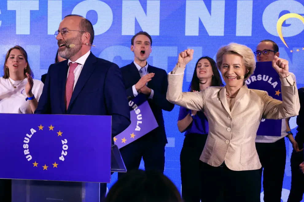 Lead candidate for the European Commission, current European Commission President Ursula von der Leyen, right, poses as party president Manfred Weber speaks during an event at the European People's Party headquarters in Brussels, Sunday, June 9, 2024. Polling stations opened across Europe on Sunday as voters from 20 countries cast ballots in elections that are expected to shift the European Union's parliament to the right and could reshape the future direction of the world's biggest trading bloc. (AP Photo/Geert Vanden Wijngaert)