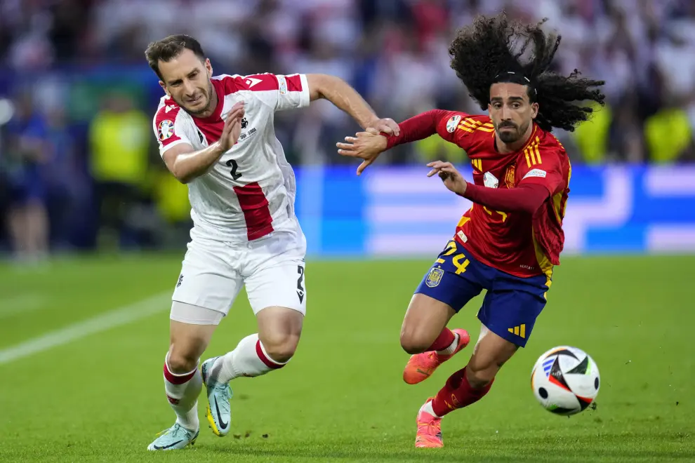 Georgia's Otar Kakabadze, left, challenges Spain's Marc Cucurella during a round of sixteen match between Spain and Georgia at the Euro 2024 soccer tournament in Cologne, Germany, Sunday, June 30, 2024. (AP Photo/Manu Fernandez)