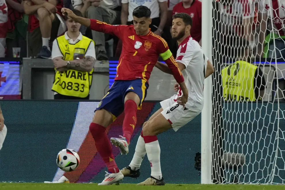 Spain's Alvaro Morata, front, controls a ball challenged by Georgia's Lasha Dvali during a round of sixteen match at the Euro 2024 soccer tournament in Cologne, Germany, Sunday, June 30, 2024. (AP Photo/Frank Augstein)