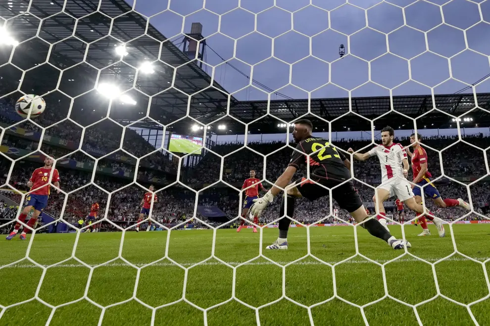 Georgia's Khvicha Kvaratskhelia, second right, celebrates after Spain's Robin Le Normand, right, scored an own goal during a round of sixteen match between Spain and Georgia at the Euro 2024 soccer tournament in Cologne, Germany, Sunday, June 30, 2024. (AP Photo/Frank Augstein)