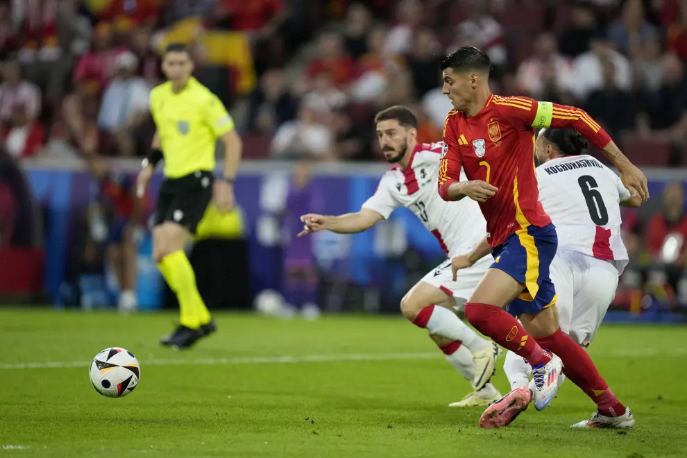 Spain's Alvaro Morata fights for the ball against Georgia's Giorgi Kochorashvili during a round of sixteen match between Spain and Georgia at the Euro 2024 soccer tournament in Cologne, Germany, Sunday, June 30, 2024. (AP Photo/Darko Vojinovic)