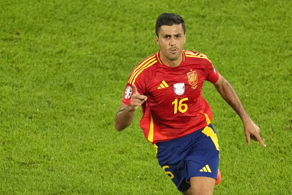 Spain's Rodri celebrates after scoring his side's opening goal during a round of sixteen match between Spain and Georgia at the Euro 2024 soccer tournament in Cologne, Germany, Sunday, June 30, 2024. (AP Photo/Andreea Alexandru)