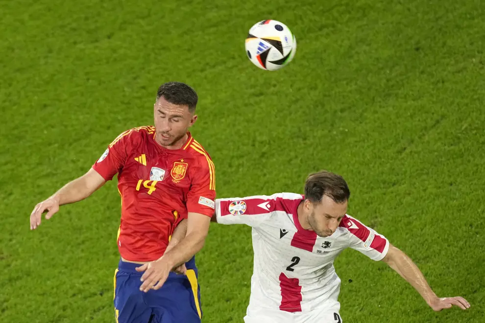Spain's Aymeric Laporte, right, challenges for the ball with Georgia's Otar Kakabadze during a round of sixteen match between Spain and Georgia at the Euro 2024 soccer tournament in Cologne, Germany, Sunday, June 30, 2024. (AP Photo/Andreea Alexandru)