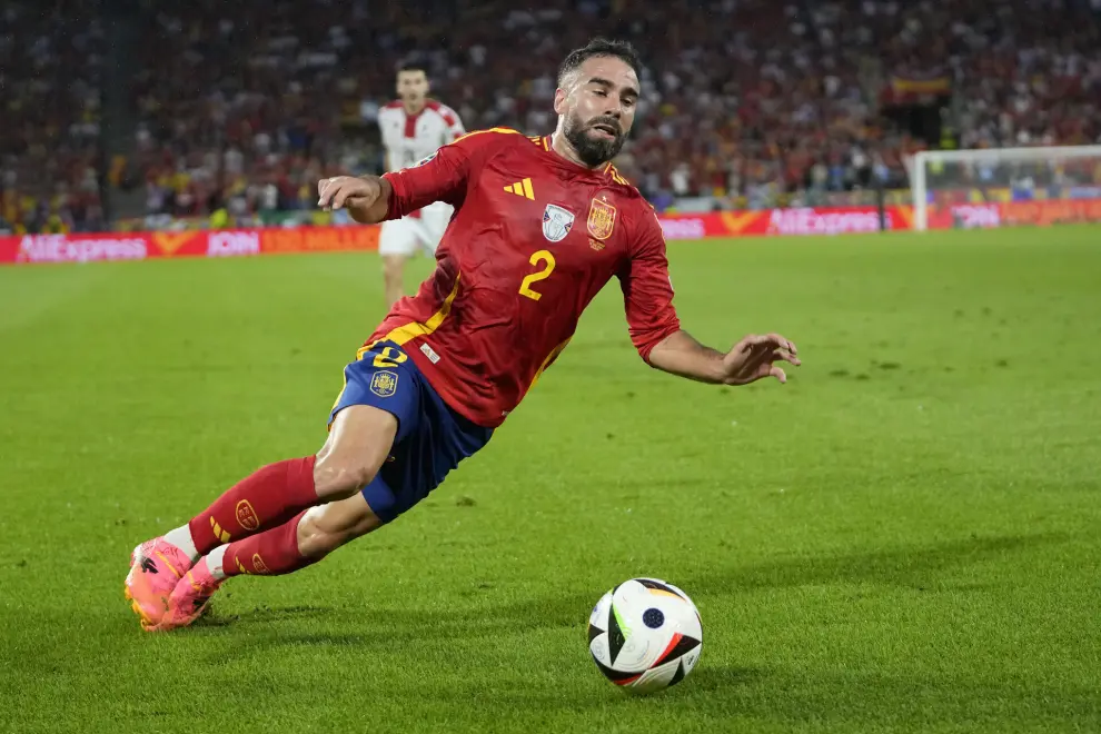 Spain's Dani Carvajal falls during a round of sixteen match between Spain and Georgia at the Euro 2024 soccer tournament in Cologne, Germany, Sunday, June 30, 2024. (AP Photo/Darko Vojinovic)