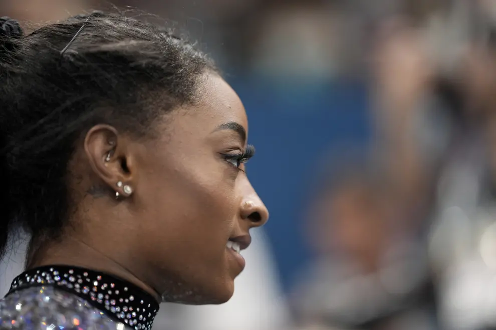 Simone Biles, of United States, waits to compete on the uneven bars during a women's artistic gymnastics qualification round at Bercy Arena at the 2024 Summer Olympics, Sunday, July 28, 2024, in Paris, France. (AP Photo/Charlie Riedel)
