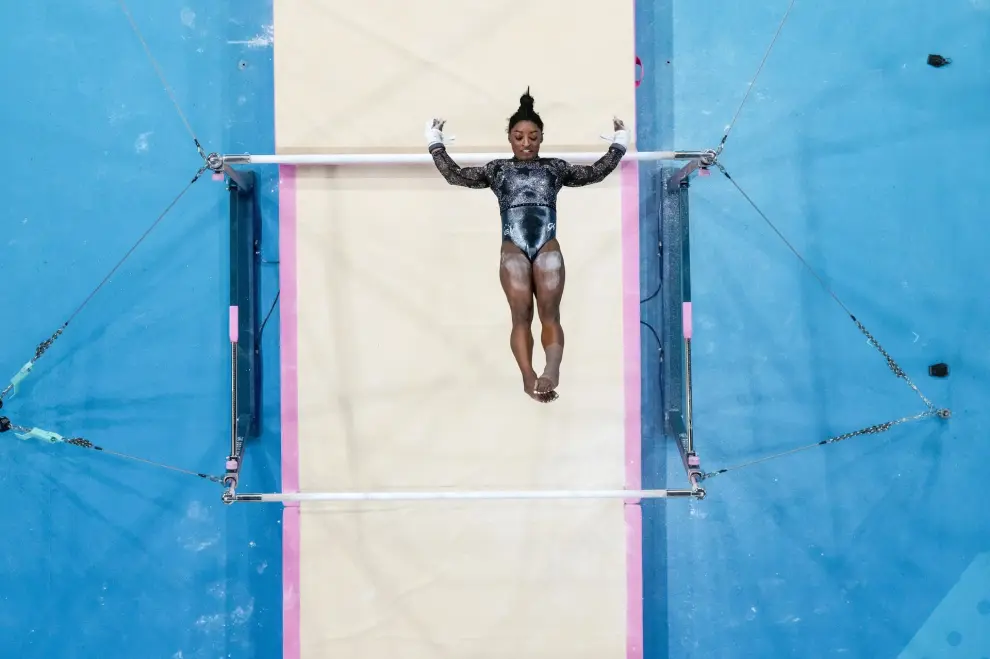 Simone Biles, of United States, performs on the uneven bars during a women's artistic gymnastics qualification round at the 2024 Summer Olympics, Sunday, July 28, 2024, in Paris, France. (AP Photo/Morry Gash)
