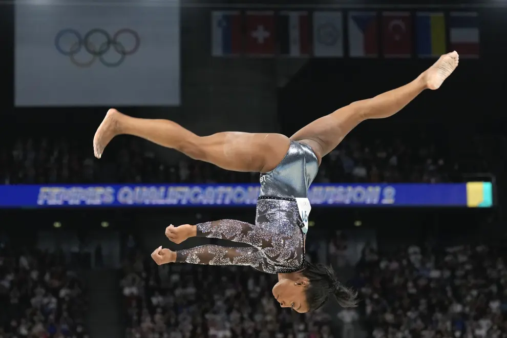 Simone Biles competes on the balance beam during a women's artistic gymnastics qualification round at the 2024 Summer Olympics, Sunday, July 28, 2024, in Paris, France. (AP Photo/Abbie Parr)