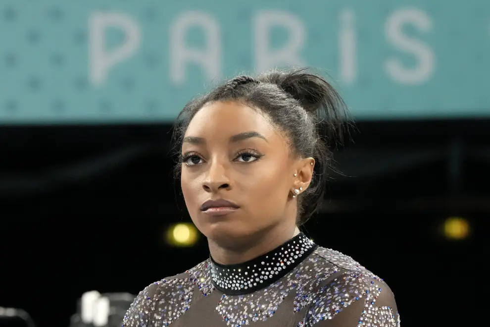 Simone Biles of the United States waits to compete on the balance beam during a women's artistic gymnastics qualification round at the 2024 Summer Olympics, Sunday, July 28, 2024, in Paris, France. (AP Photo/Charlie Riedel)