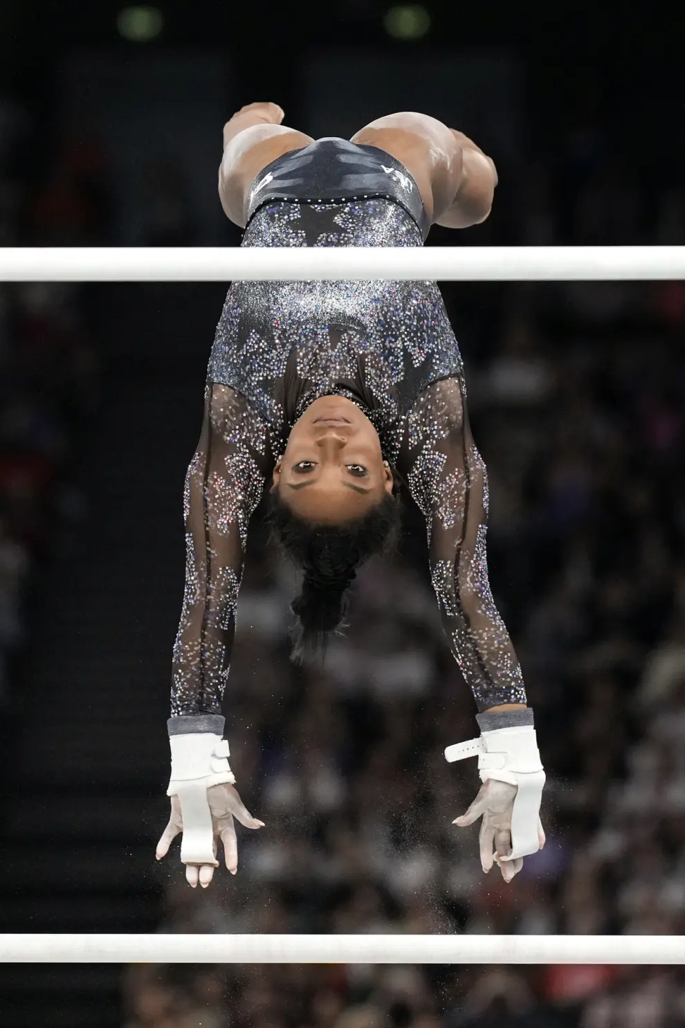 Simone Biles, of United States, competes on the uneven bars during a women's artistic gymnastics qualification round at Bercy Arena at the 2024 Summer Olympics, Sunday, July 28, 2024, in Paris, France. (AP Photo/Abbie Parr)