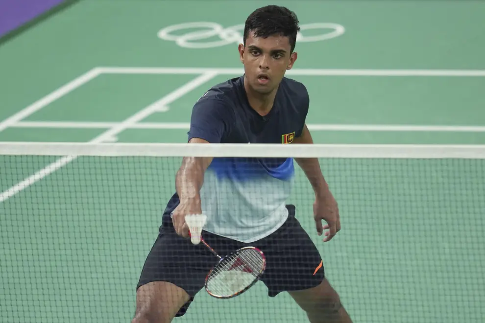 Sri Lanka's Viren Nettasinghe plays against Spain's Pablo Abian during their men's singles badminton group stage match at the 2024 Summer Olympics, Tuesday, July 30, 2024, in Paris, France. (AP Photo/Kin Cheung)