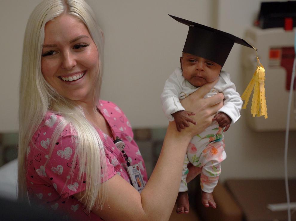 In this picture received by AFP from Sharp Mary Birch Hospital for Women & Newborns on May 29, 2019, shows a nurse holding baby Saybie, the world's smallest surviving newborn, on the day she was released from the NICU in San Diego, California. - A baby girl who weighed 245 grams and measured 23 cm became the smallest baby in the world, a US hospital reported after being discharged five months after being in intensive care. (Photo by HO / Sharp HealthCare. / AFP) / RESTRICTED TO EDITORIAL USE - MANDATORY CREDIT "AFP PHOTO / Sharp HealthCare/HO" - NO MARKETING NO ADVERTISING CAMPAIGNS - DISTRIBUTED AS A SERVICE TO CLIENTS US-health-infants