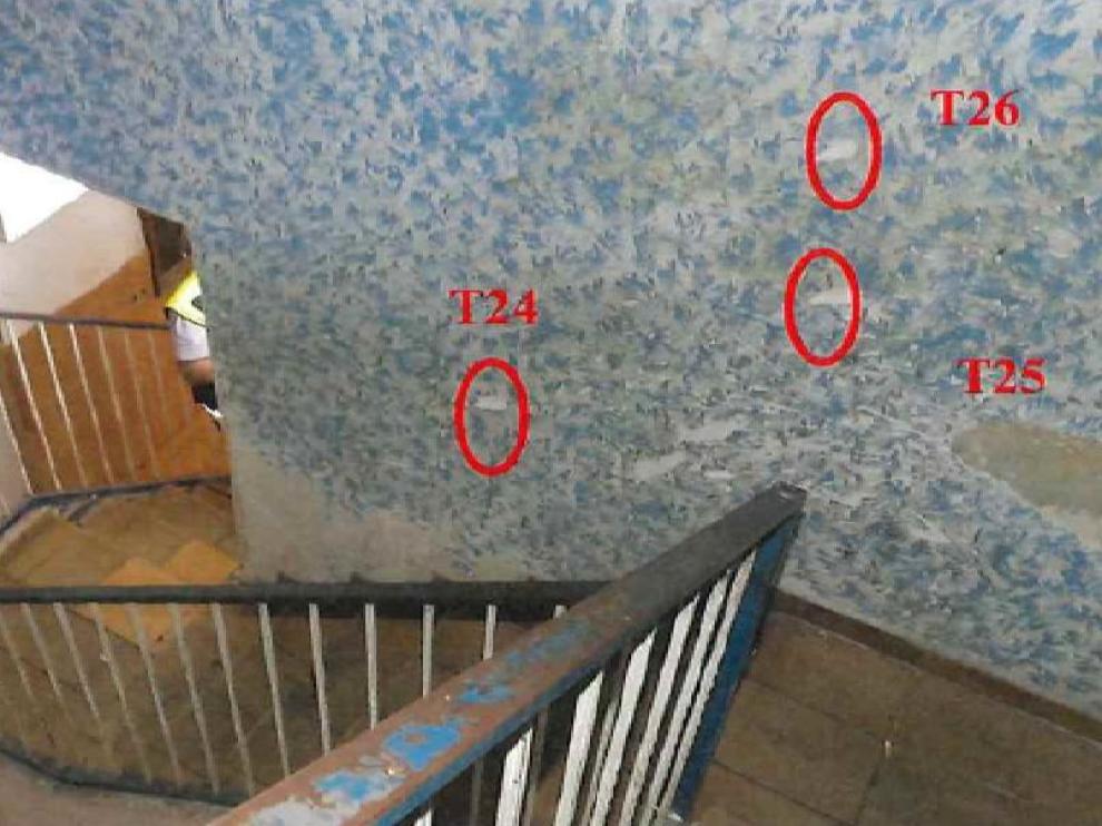 Marcados en la pared de la escalera, tres de los once disparos que efectuaron los policías en el portal del número 76 de la calle Pignatelli de Zaragoza.