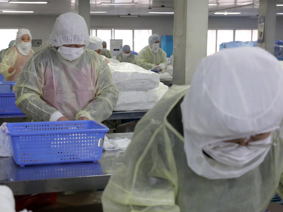 Varios trabajadores, en una fábrica de mascarillas en la ciudad china de Nantong.