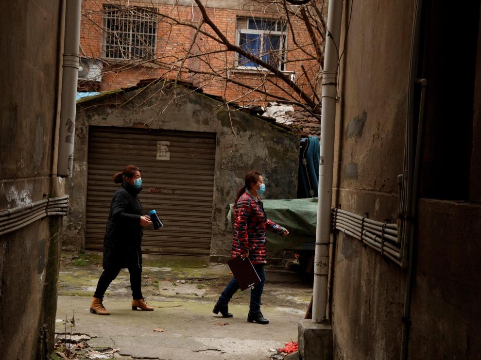 Los miembros de un comité vecinal informan de las novedades de la enfermedad en Juijuang, China.