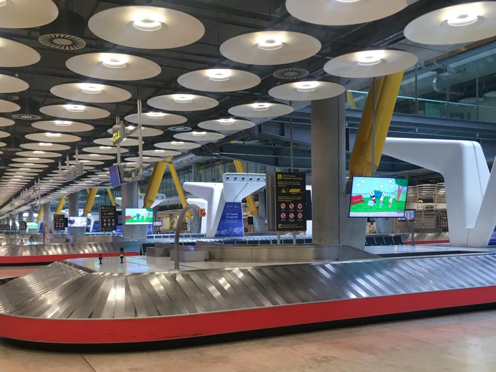 Empty baggage carousels are seen at Madrid's Adolfo Suarez Barajas Airport