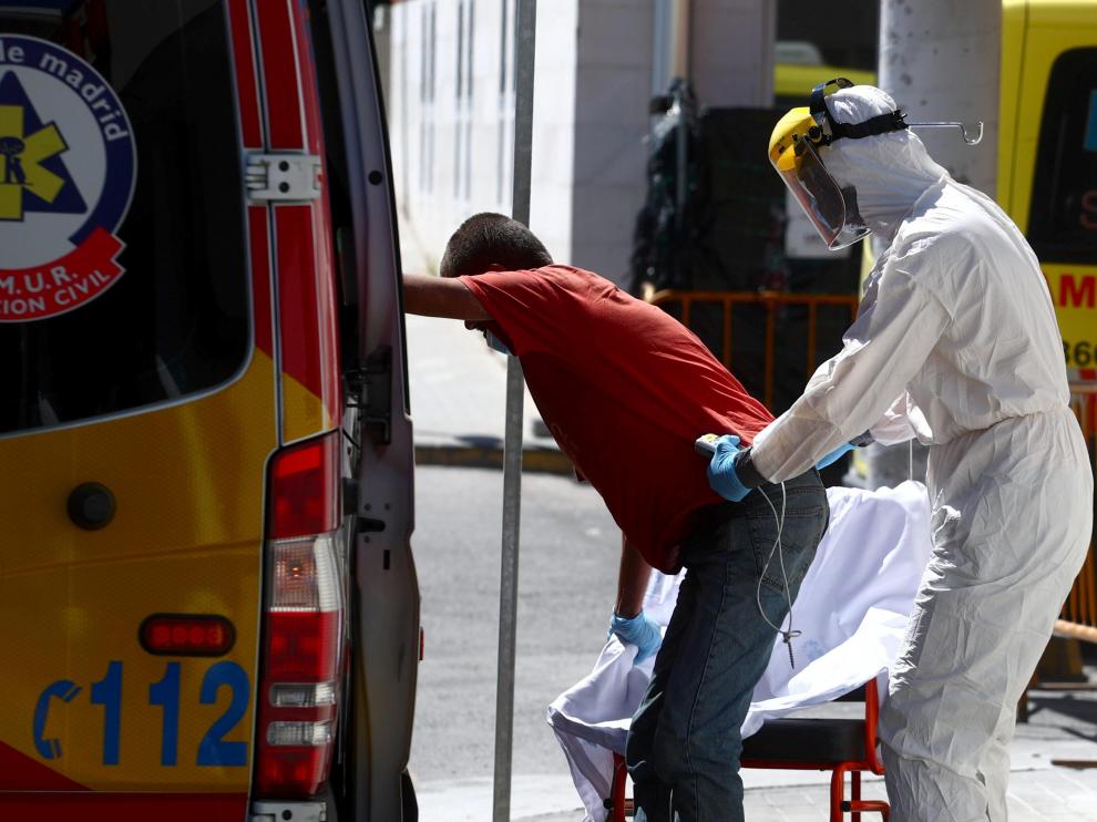 A health worker wearing personal protective equipment, arrives at the emergency unit at 12 de Octubre hospital in Madrid
