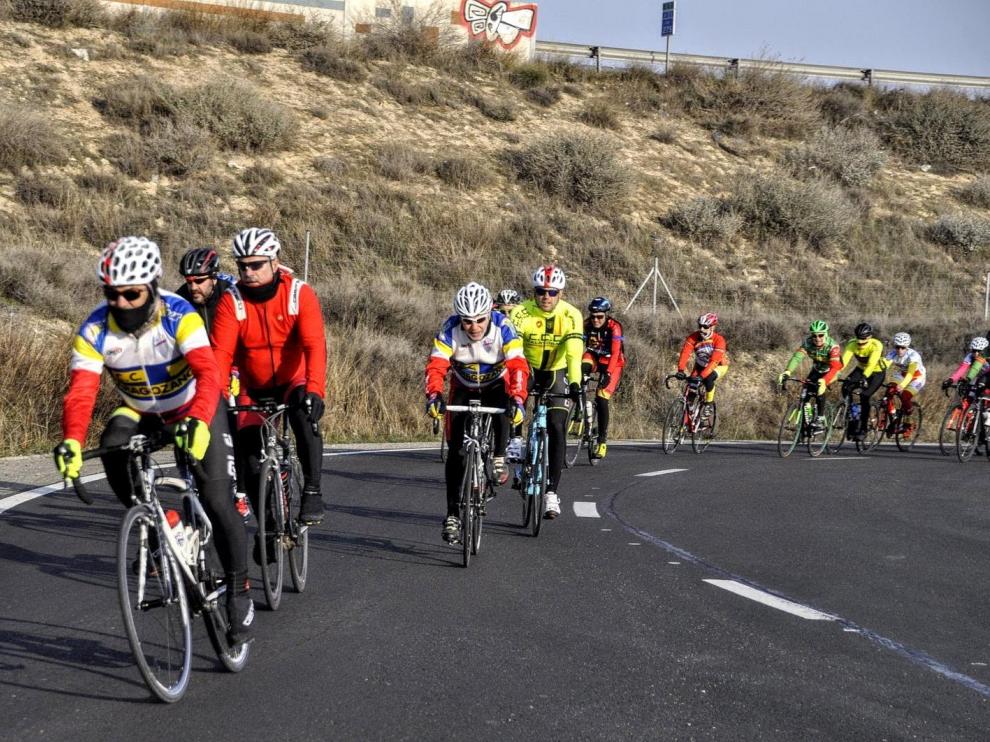 Un 'pequeño pelotón' cicloturista del Club Ciclista Zaragozano circula por las afueras de la capital.