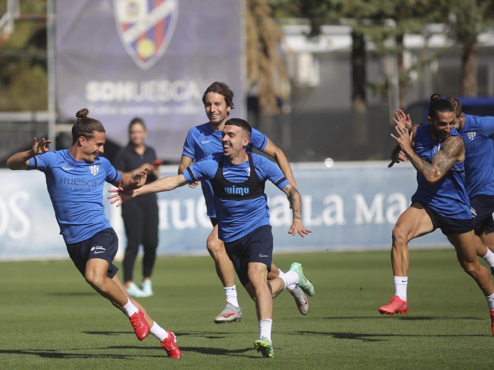 Seoane corre perseguido por varios de sus compañeros de la SD Huesca en el entrenamiento del domingo.