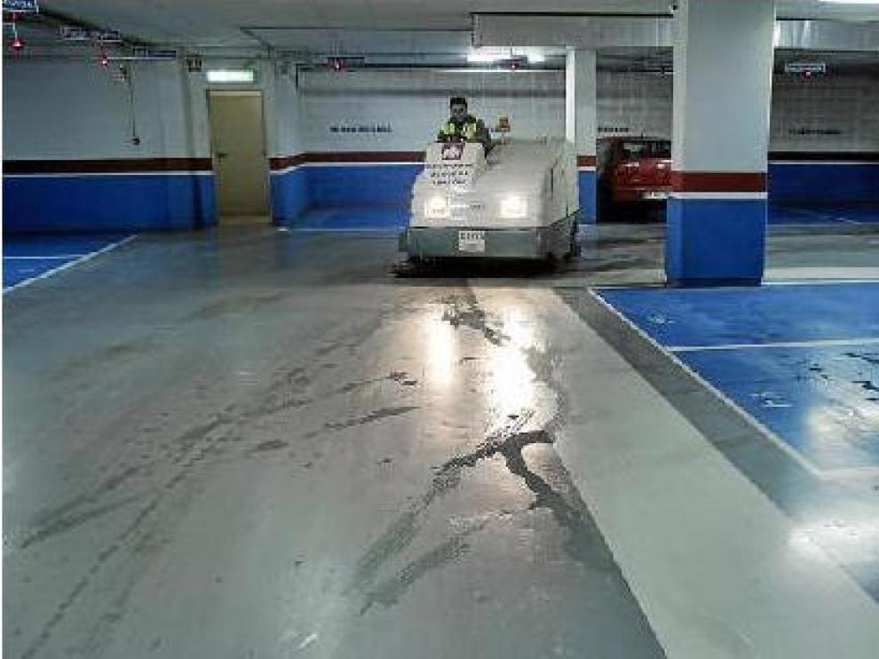 Un operario de la empresa que explota el parquin limpia el agua que entra a través del techo y las paredes.