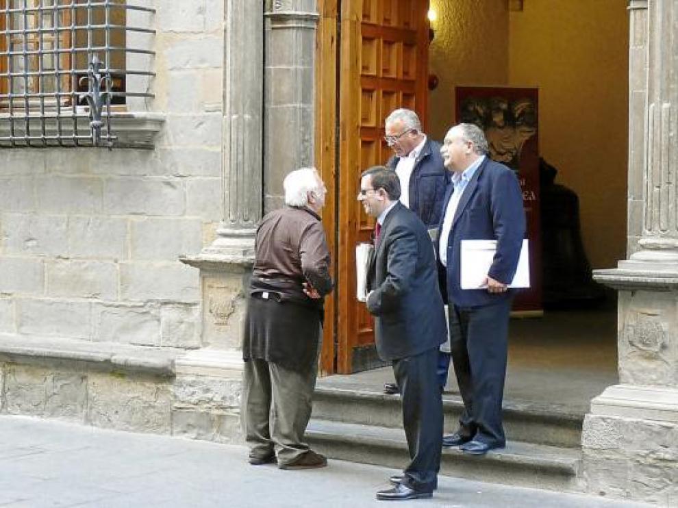 Un vecino saluda a Enrique Villarroya, José María Abarca y Juan David Vila a la salida de la comisión.