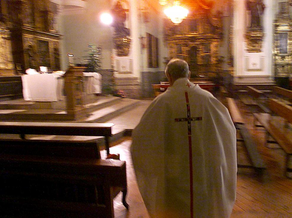 Un sacerdote sale a oficiar misa en una parroquia de Zaragoza