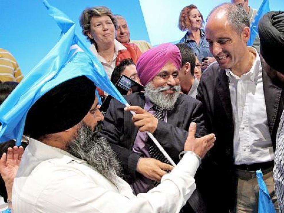 Francisco Camps saluda a un grupo de simpatizantes sijs en el acto de ayer en Valencia.