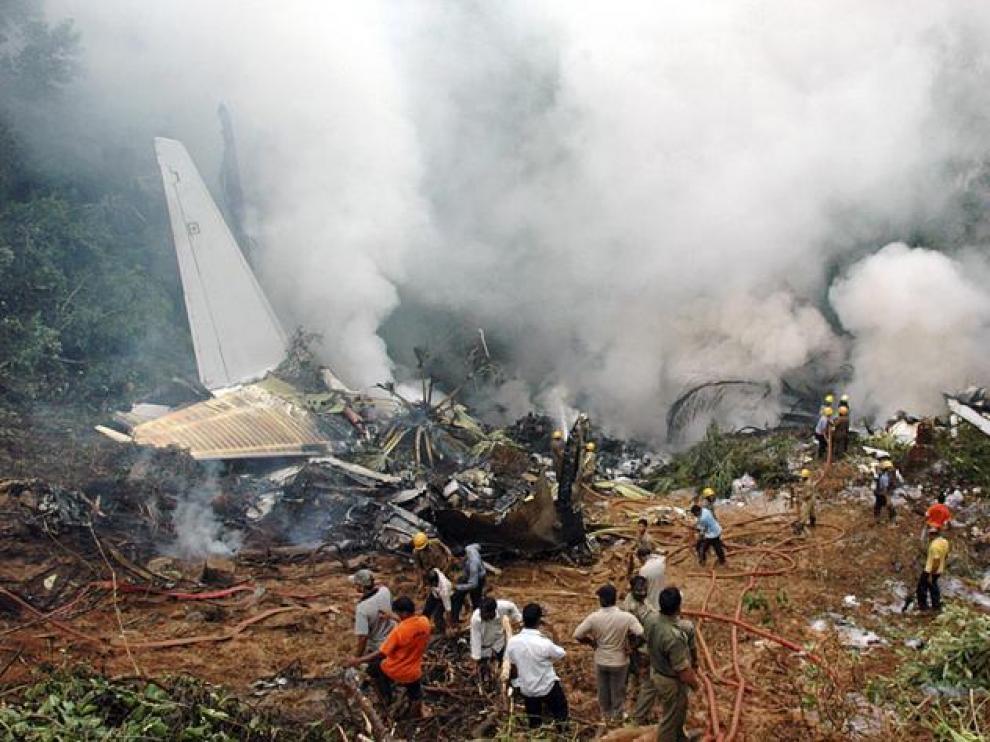 Los bomberos tratan de sofocar las llamas de los restos del avión accidentado en el estado indio de Mangalore.