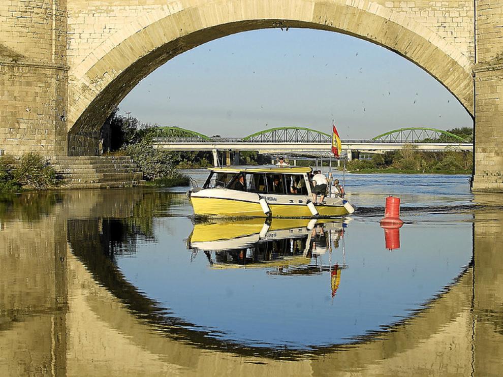 Los Ebrobuses -en la imagen, ayer, con el alcalde a bordo- no superarán hoy el puente de Piedra