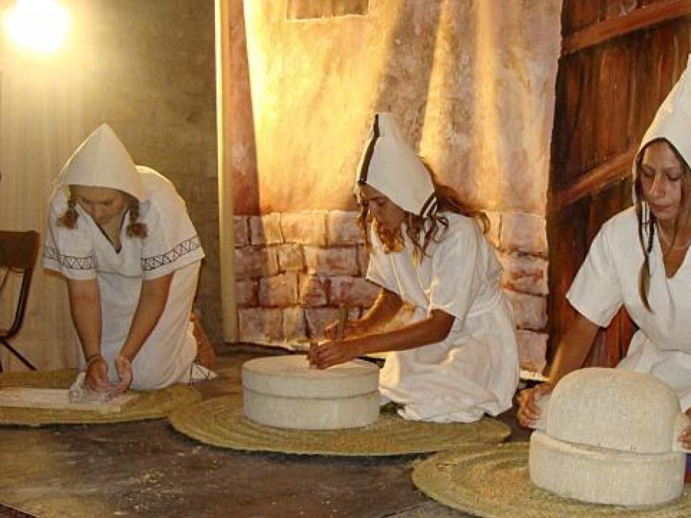 El grupo de recreación Ositanos mostró cómo molía el grano y amasaba el pan el pueblo ibero.