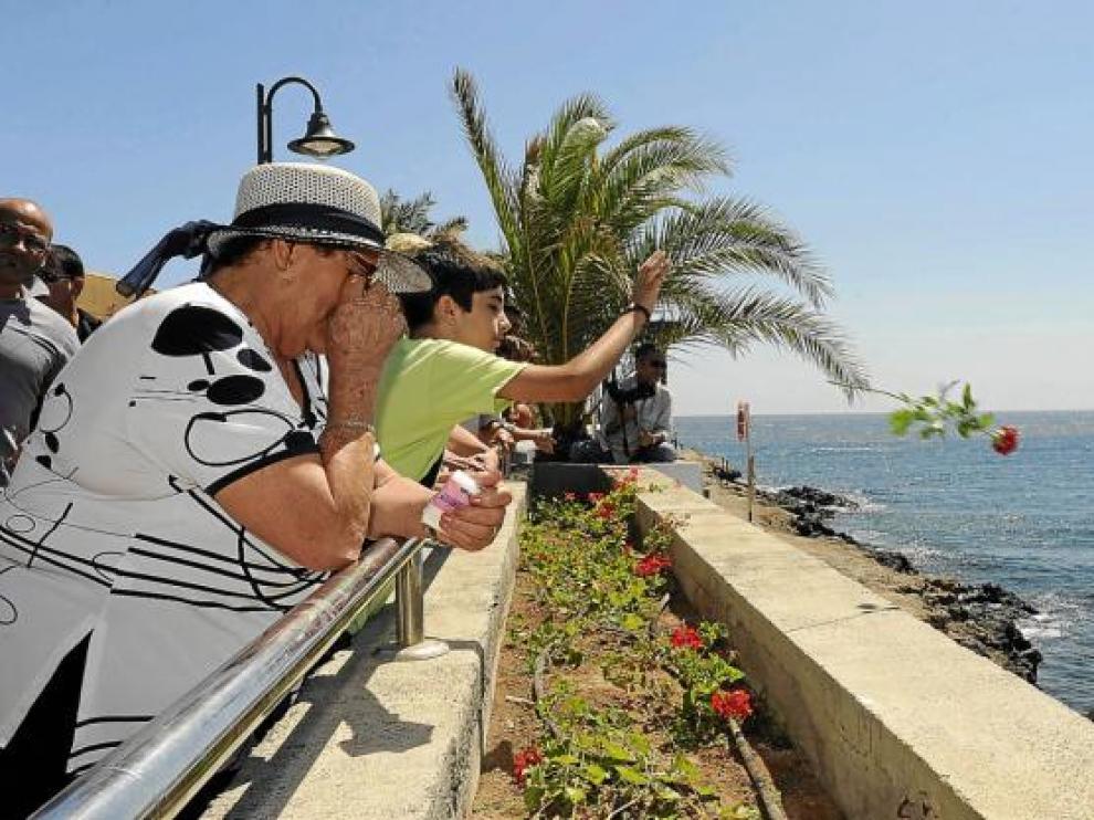 Familiares de fallecidos en el accidente lanzan flores al mar, ayer en Ojos de Garza (Gran Canaria).