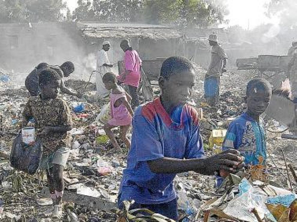 Varios niños de Mali recogen basura en un vertedero.