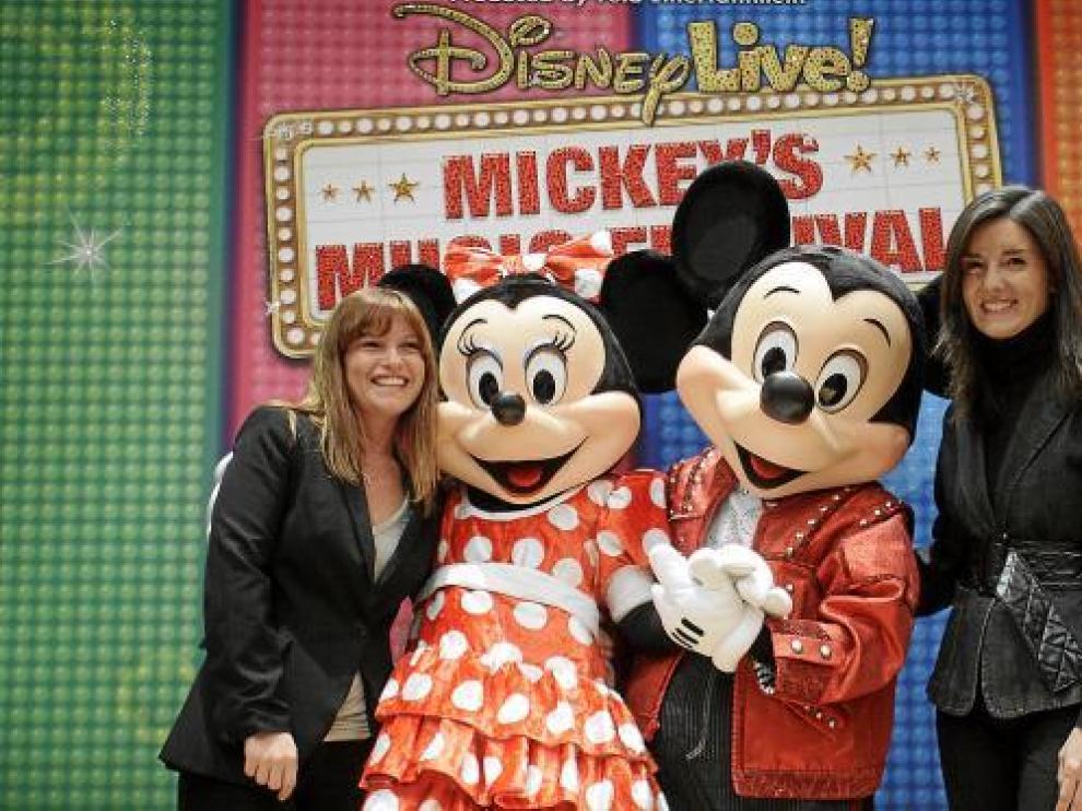 Liliana Rossi (i), de Proactiv, y María Campo (d), de la CAI, junto a Minnie y Mickey.