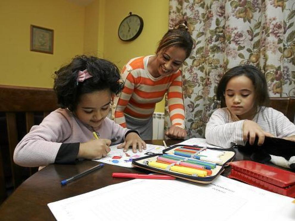 Amina y Sofía hacían ayer sus deberes con su madre Jamila, en su casa de Santa Cilia.