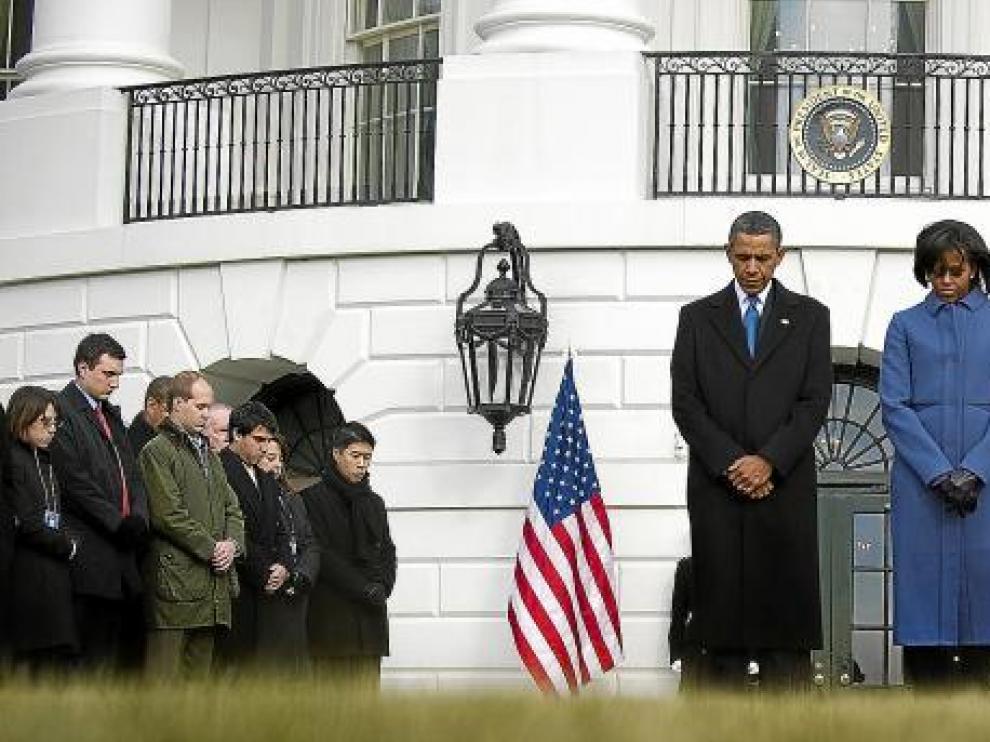 El presidente de Estados Unidos, Barack Obama (centro), y su esposa, Michelle, guardan un minuto de silencio, ayer en la Casa Blanca en Washington.