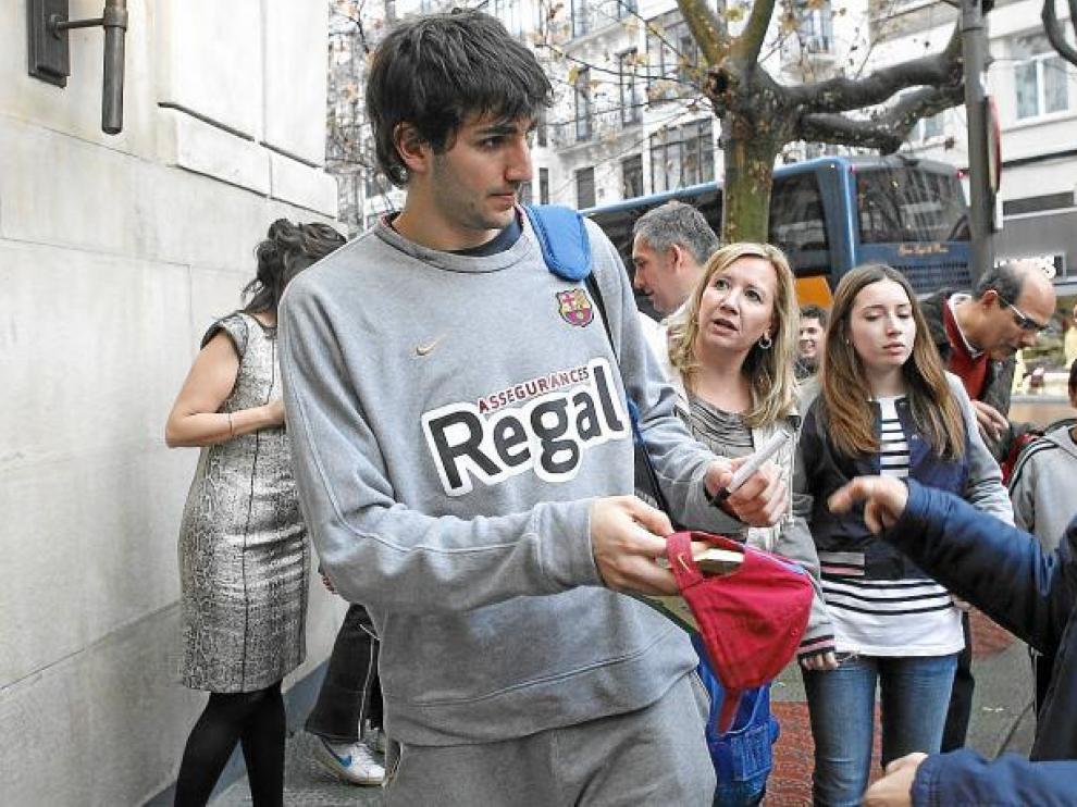 Ricky Rubio firma un autógrafo en la gorra de un aficionado a su llegada al Gran Hotel de Zaragoza.