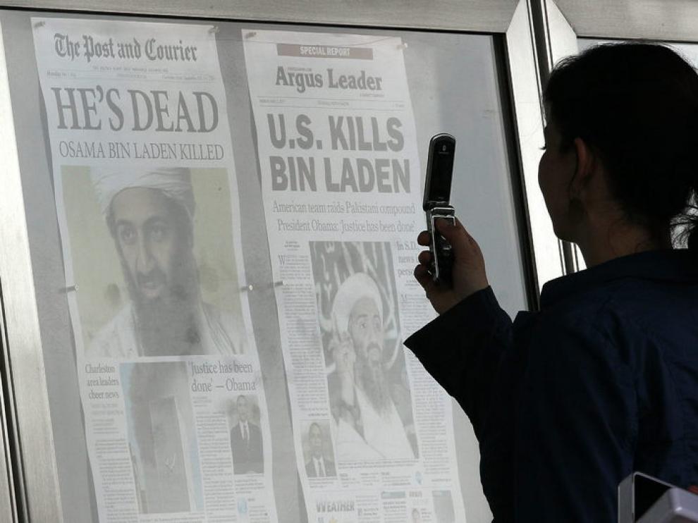 Una chica fotografía las portadas de los periódicos en Washington