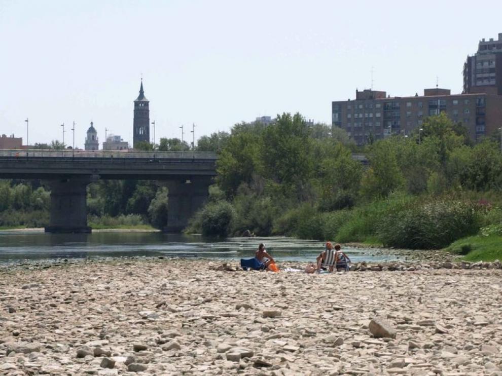 Algunas bañistas toman el sol, a orillas del Ebro, entre chapuzón y chapuzón.